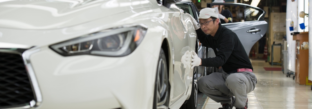 INFINITI Technician Inspecting White Sedan